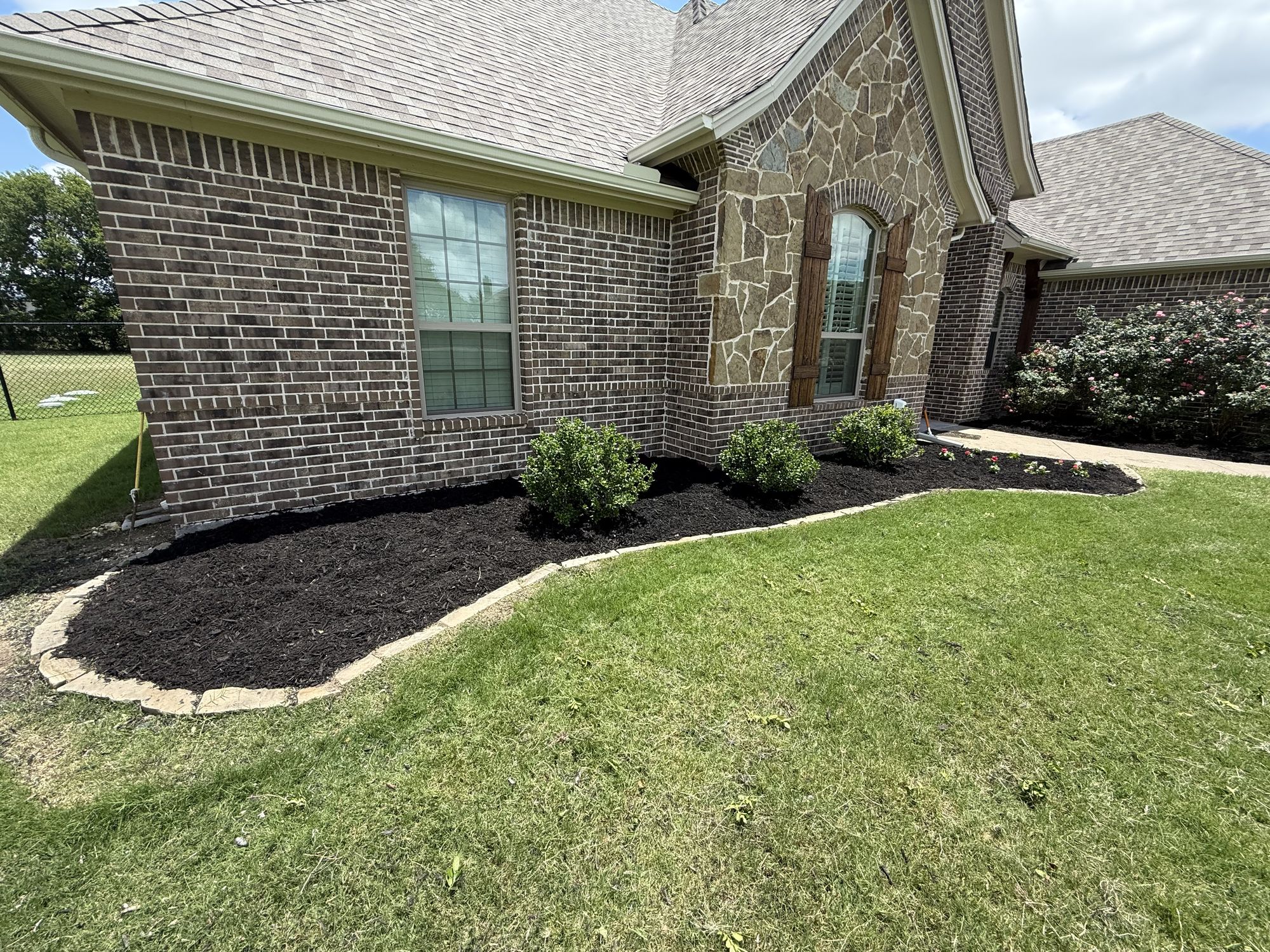 Front flowerbeds with fresh dark mulch and clean edging